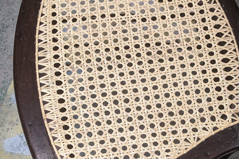 close up of weaved cane chair seat.